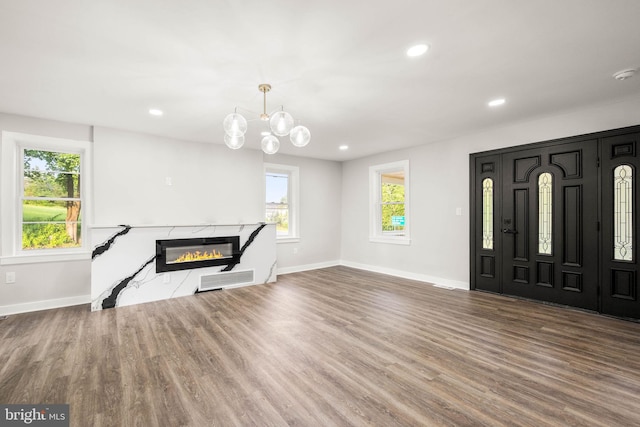 8255 Mertztown Rd, Alburtis, PA 18011 - unfurnished living room featuring baseboards, wood finished floors, plenty of natural light, recessed lighting, and a premium fireplace