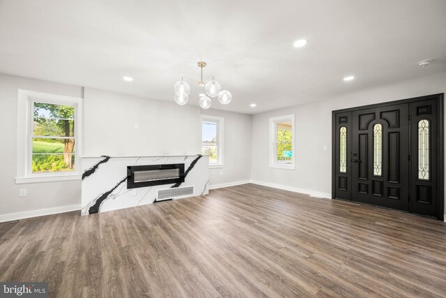 8255 Mertztown Rd, Alburtis, PA 18011 - foyer entrance featuring baseboards, wood finished floors, recessed lighting, a chandelier, and a high end fireplace