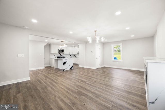 8255 Mertztown Rd, Alburtis, PA 18011 - unfurnished living room featuring recessed lighting, baseboards, wood finished floors, and a chandelier