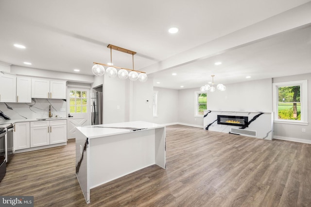 8255 Mertztown Rd, Alburtis, PA 18011 - kitchen featuring freestanding refrigerator, a center island, recessed lighting, wood finished floors, and white cabinets