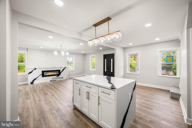 8255 Mertztown Rd, Alburtis, PA 18011 - kitchen featuring open floor plan, recessed lighting, baseboards, white cabinets, and wood finished floors