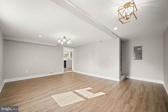 8255 Mertztown Rd, Alburtis, PA 18011 - unfurnished living room with a chandelier, electric panel, stairway, recessed lighting, and light wood-style flooring