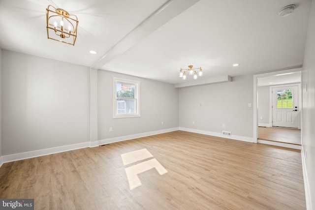 8255 Mertztown Rd, Alburtis, PA 18011 - empty room with a chandelier, plenty of natural light, recessed lighting, light wood-type flooring, and baseboards