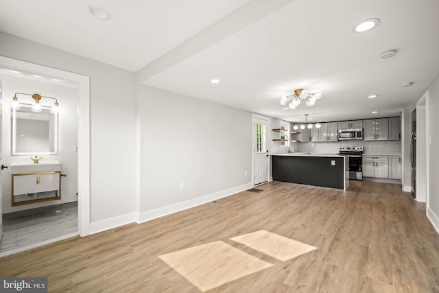 8255 Mertztown Rd, Alburtis, PA 18011 - unfurnished living room with light wood-style flooring, baseboards, recessed lighting, and a chandelier