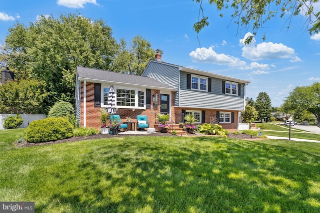 8400 Saunders Rd, Lutherville Timonium, MD 21093 - tri-level home featuring brick siding, a chimney, and a front lawn