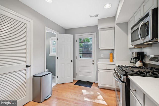 104 S St, Annapolis, MD 21401 - kitchen featuring stainless steel appliances, light countertops, white cabinetry, light wood finished floors, and recessed lighting