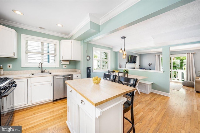 1323 Washington Dr, Annapolis, MD 21403 - kitchen featuring dishwasher, a sink, black range with gas cooktop, a breakfast bar area, and white cabinetry