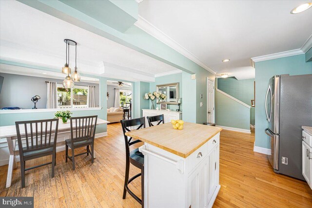 1323 Washington Dr, Annapolis, MD 21403 - kitchen featuring freestanding refrigerator, crown molding, white cabinetry, light wood-style flooring, and baseboards