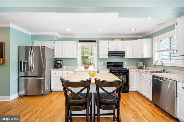 1323 Washington Dr, Annapolis, MD 21403 - kitchen featuring appliances with stainless steel finishes, a sink, under cabinet range hood, white cabinets, and ornamental molding