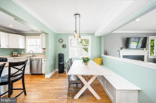 1323 Washington Dr, Annapolis, MD 21403 - dining room featuring ornamental molding, light wood-style flooring, a fireplace, recessed lighting, and baseboards