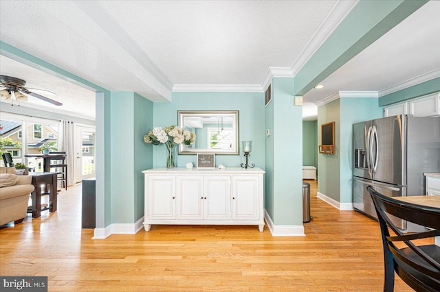 1323 Washington Dr, Annapolis, MD 21403 - kitchen featuring stainless steel refrigerator with ice dispenser, baseboards, ornamental molding, white cabinets, and light wood-style floors