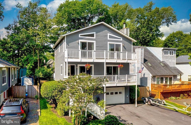 1323 Washington Dr, Annapolis, MD 21403 - view of front of home with a garage, a chimney, driveway, and a balcony