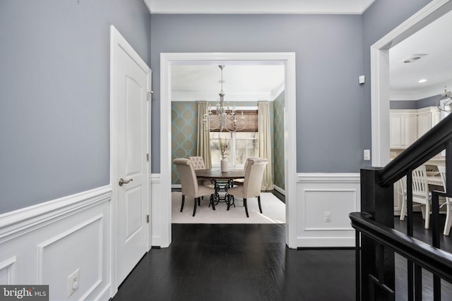 1200 Prince Edward St, Fredericksburg, VA 22401 - dining area with a chandelier, ornamental molding, a wainscoted wall, dark wood-type flooring, and a decorative wall