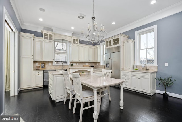 1200 Prince Edward St, Fredericksburg, VA 22401 - kitchen featuring built in refrigerator, a kitchen island, a chandelier, glass insert cabinets, and crown molding