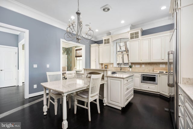 1200 Prince Edward St, Fredericksburg, VA 22401 - kitchen with a kitchen breakfast bar, crown molding, backsplash, a chandelier, and light stone counters