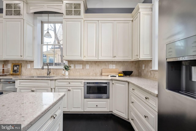 1200 Prince Edward St, Fredericksburg, VA 22401 - kitchen featuring a sink, white cabinets, glass insert cabinets, and light stone counters