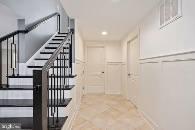 1200 Prince Edward St, Fredericksburg, VA 22401 - stairs featuring a decorative wall, a wainscoted wall, tile patterned flooring, and recessed lighting