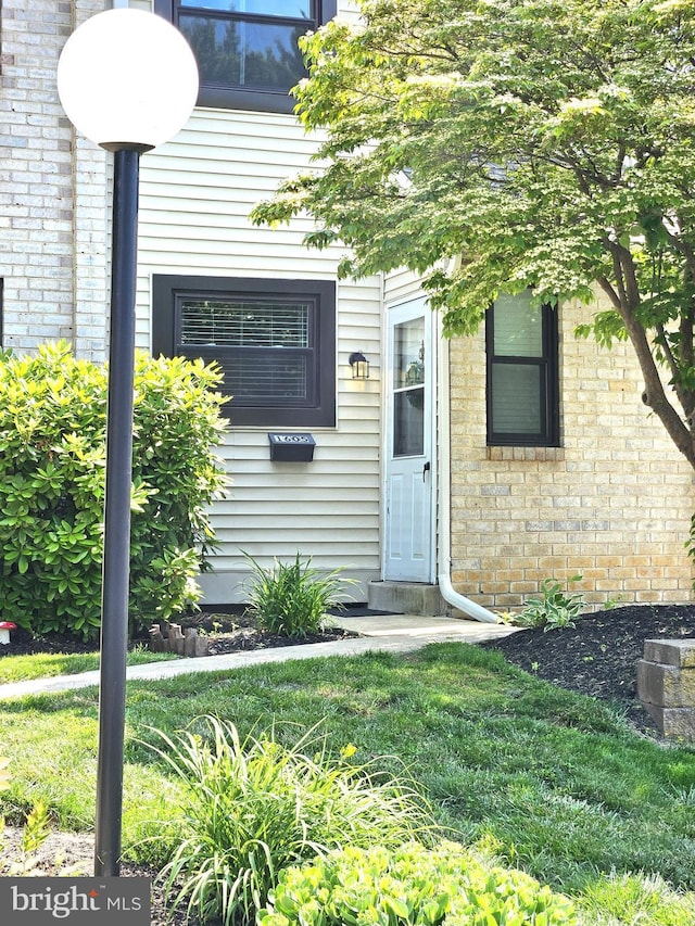 1605 Valley Dr Unit 1605, West Chester, PA 19382 - property entrance featuring brick siding and a lawn