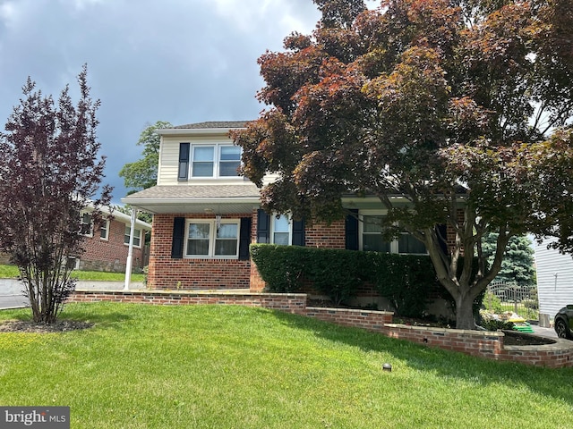 2317 Poplar Rd Unit 24, Havertown, PA 19083 - view of property hidden behind natural elements with a front yard, brick siding, and covered porch