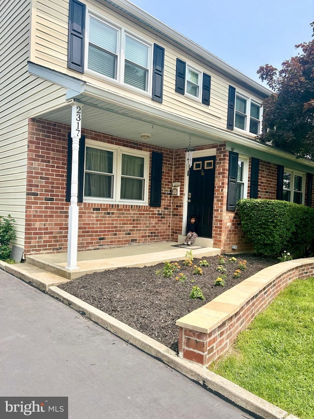 2317 Poplar Rd Unit 24, Havertown, PA 19083 - traditional home featuring a porch and brick siding