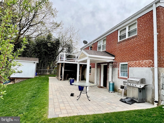 10213 Duvawn Pl, Silver Spring, MD 20902 - back of house featuring a yard, a patio, brick siding, and a balcony