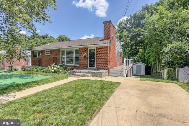 10213 Duvawn Pl, Silver Spring, MD 20902 - view of front of house featuring a storage shed, brick siding, and a chimney