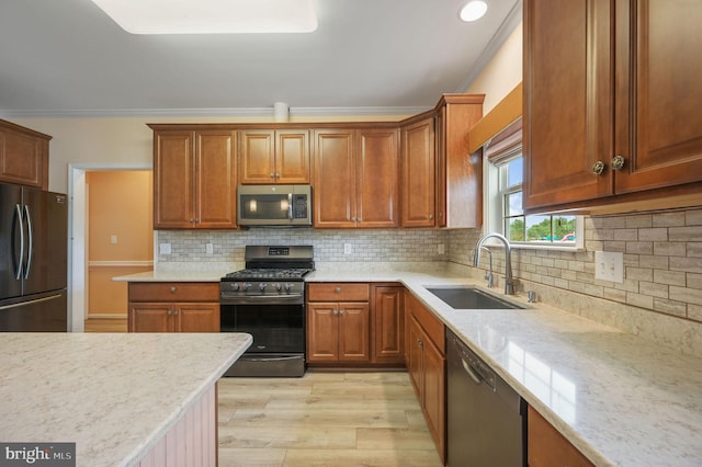44 Homberg Cir, Dover, DE 19904 - kitchen with stainless steel appliances, ornamental molding, light wood finished floors, a sink, and backsplash