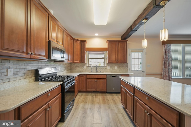 44 Homberg Cir, Dover, DE 19904 - kitchen featuring stainless steel appliances, a sink, light wood-type flooring, backsplash, and brown cabinets