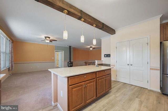 44 Homberg Cir, Dover, DE 19904 - kitchen with a ceiling fan, freestanding refrigerator, pendant lighting, open floor plan, and brown cabinetry