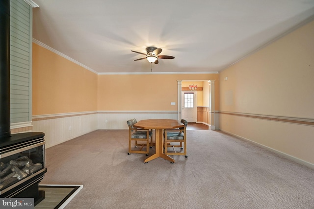 44 Homberg Cir, Dover, DE 19904 - unfurnished dining area with a wood stove, a ceiling fan, ornamental molding, carpet, and wainscoting