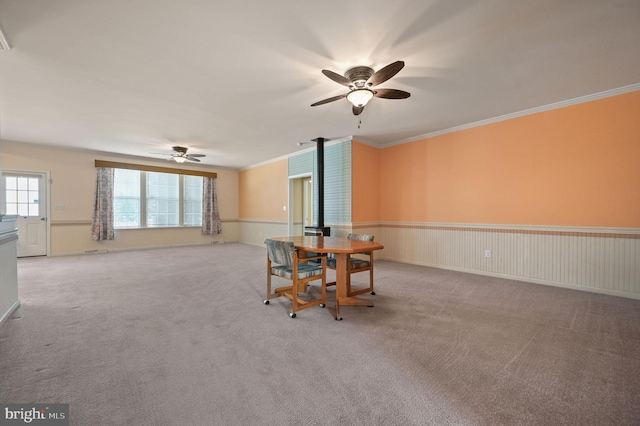44 Homberg Cir, Dover, DE 19904 - carpeted dining area with a ceiling fan, ornamental molding, a wood stove, and wainscoting