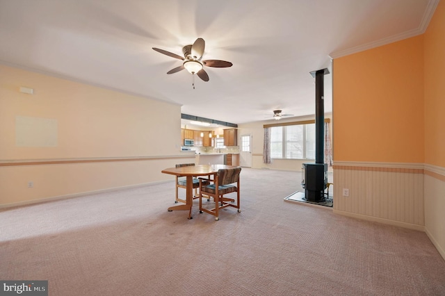 44 Homberg Cir, Dover, DE 19904 - dining room featuring ceiling fan, a wood stove, and light colored carpet