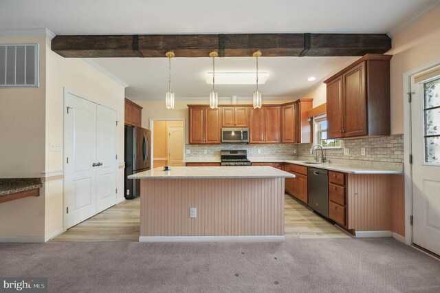 44 Homberg Cir, Dover, DE 19904 - kitchen featuring appliances with stainless steel finishes, crown molding, light countertops, decorative backsplash, and a center island