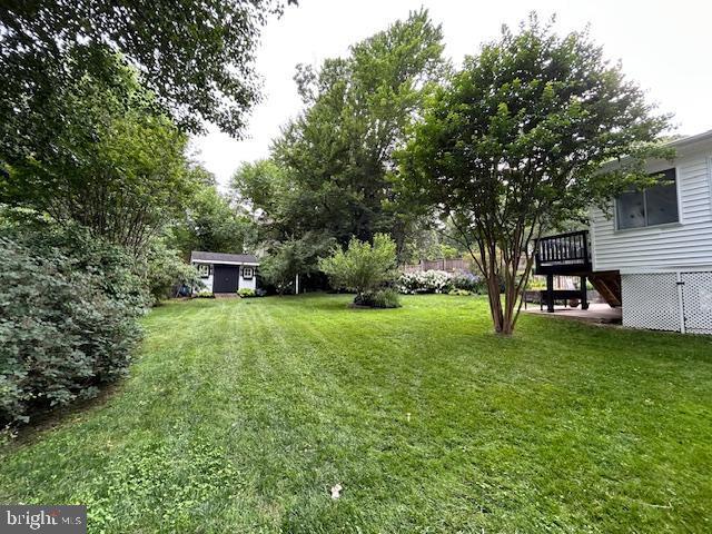 1247 Silver Run Dr, Pasadena, MD 21122 - view of green lawn with stairway and a wooden deck