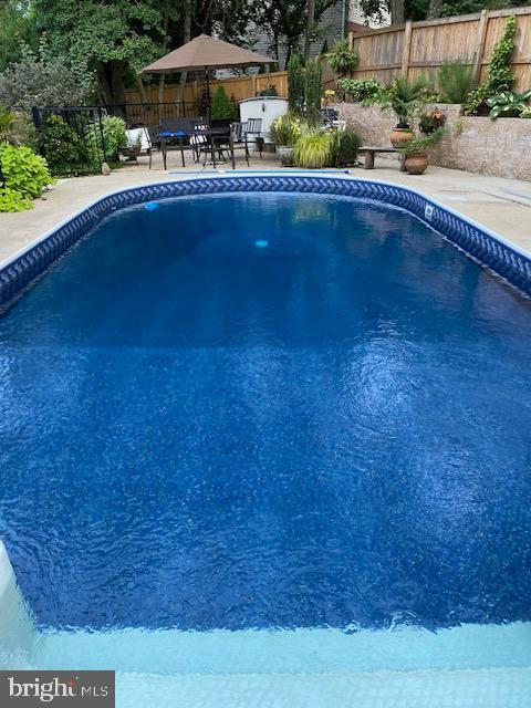 1247 Silver Run Dr, Pasadena, MD 21122 - view of pool featuring a fenced backyard and a patio area