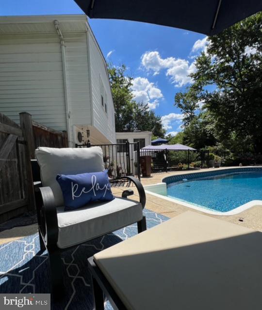 1247 Silver Run Dr, Pasadena, MD 21122 - view of swimming pool featuring a patio area