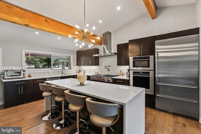 1004 Mercer Rd, Princeton, NJ 08540 - kitchen featuring stainless steel appliances, range hood, beam ceiling, backsplash, and light countertops