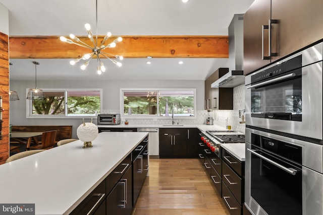 1004 Mercer Rd, Princeton, NJ 08540 - kitchen with wall chimney range hood, a chandelier, plenty of natural light, stainless steel appliances, and recessed lighting