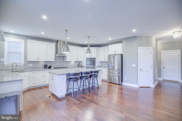 41031 Brook Grove Dr, Aldie, VA 20105 - kitchen with stainless steel appliances, wall chimney range hood, a sink, a center island, and tasteful backsplash