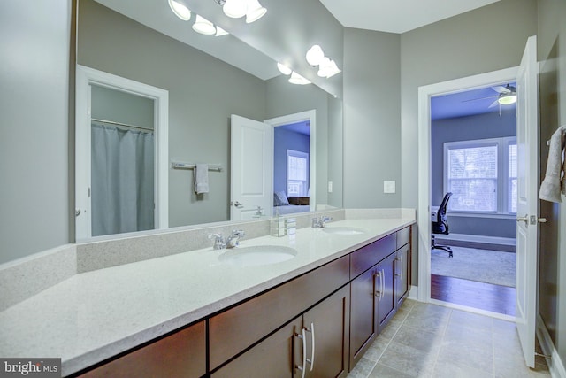 41031 Brook Grove Dr, Aldie, VA 20105 - full bath with double vanity, connected bathroom, ceiling fan, tile patterned flooring, and baseboards