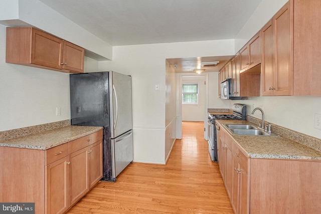 14849 Ensor Ct, Woodbridge, VA 22193 - kitchen with appliances with stainless steel finishes, a sink, light wood-style floors, and light countertops