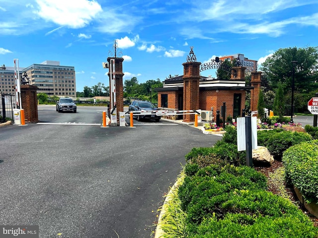 8350 Greensboro Dr Unit 218, Mclean, VA 22102 - view of asphalt road with street lighting, a gated entry, and curbs