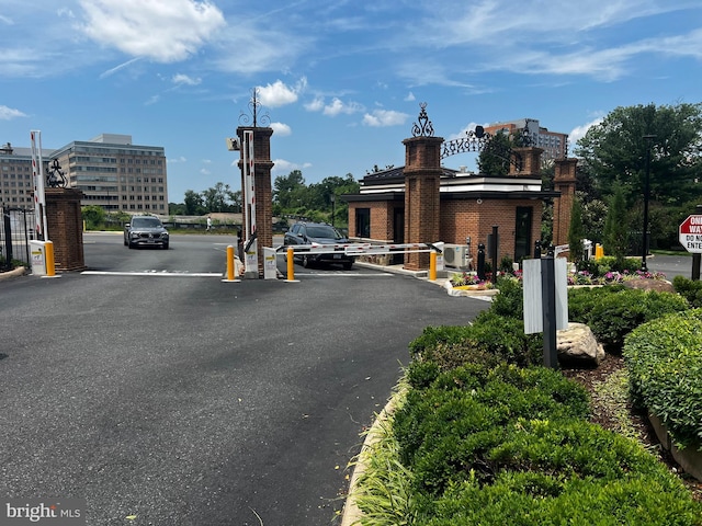 8350 Greensboro Dr Unit 218, Mclean, VA 22102 - view of asphalt road with a gated entry, street lighting, and curbs