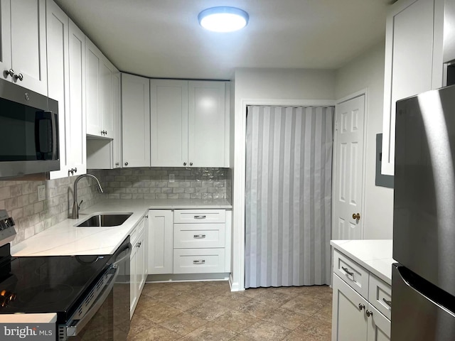 8350 Greensboro Dr Unit 218, Mclean, VA 22102 - kitchen featuring stainless steel appliances, tasteful backsplash, light countertops, and white cabinets