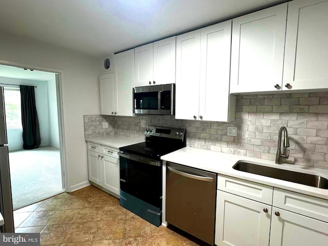 8350 Greensboro Dr Unit 218, Mclean, VA 22102 - kitchen featuring appliances with stainless steel finishes, light countertops, backsplash, and white cabinets
