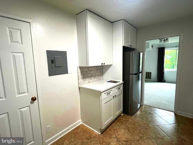 8350 Greensboro Dr Unit 218, Mclean, VA 22102 - kitchen featuring freestanding refrigerator, electric panel, light countertops, and white cabinets