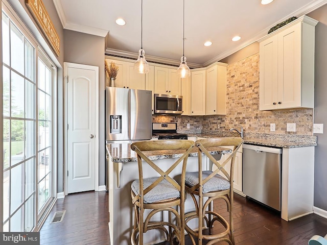 3611 Jacob Stout Rd Unit 5, Doylestown, PA 18902 - kitchen with stainless steel appliances, ornamental molding, decorative backsplash, light stone counters, and dark wood finished floors