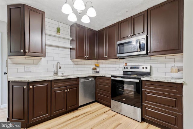 297 Killian Rd, Honey Brook, PA 19344 - kitchen with stainless steel appliances, light wood-type flooring, a chandelier, and dark brown cabinets