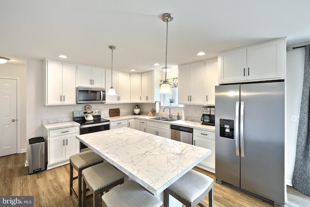 252 Valley View Cir, York, PA 17408 - kitchen featuring appliances with stainless steel finishes, a sink, light wood-type flooring, white cabinetry, and recessed lighting