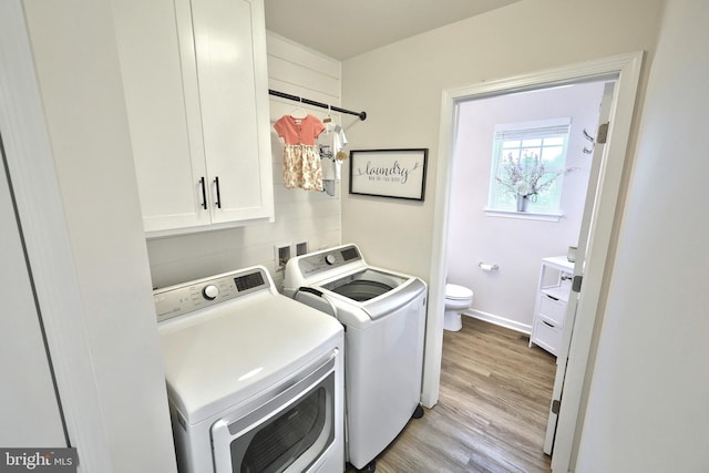 252 Valley View Cir, York, PA 17408 - laundry area featuring washer and clothes dryer, cabinet space, light wood finished floors, and baseboards